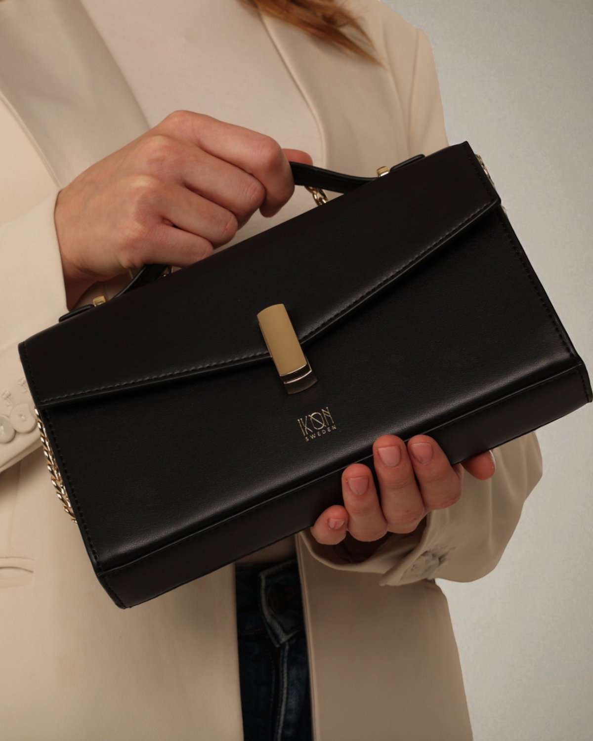 Black handbag with gold chain