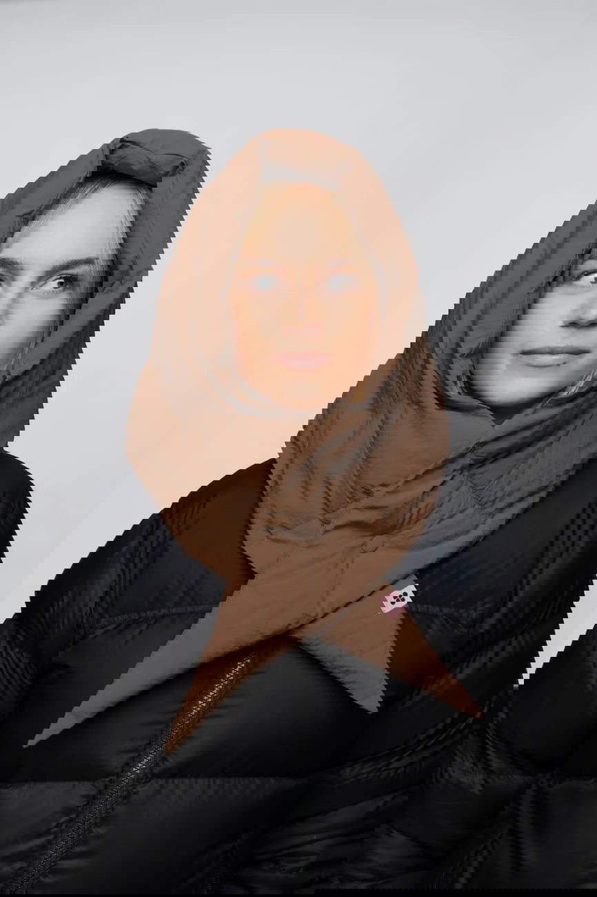 Winter Vegan Capuche Brown 5 Warm brown vegan winter capuche made from recycled materials, styled over a black puffer jacket. - The New Orchard - Warm Brown