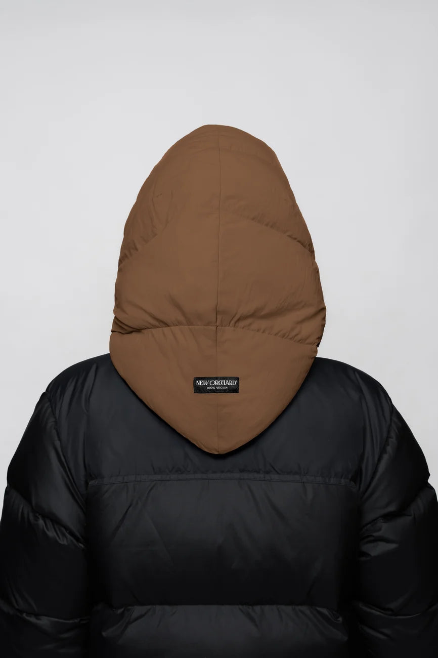 Winter Vegan Capuche Brown 6 Warm brown vegan capuche made from recycled materials, shown from the back on a black puffer jacket. - The New Orchard - Warm Brown