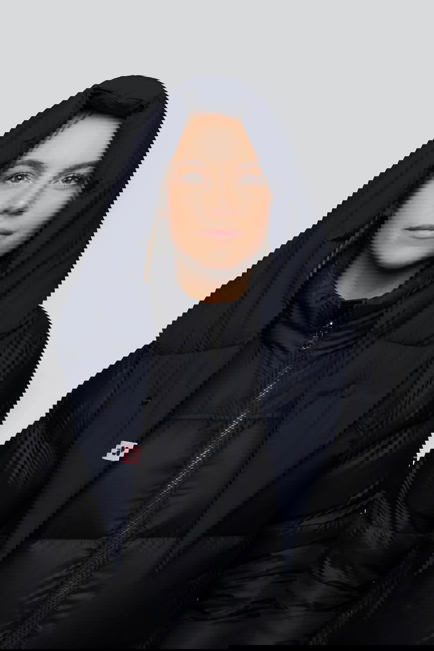 Winter Vegan Capuche Navy 3 Navy blue vegan winter capuche with padded recycled material hood on black puffer jacket. - The New Orchard - Navy Blue