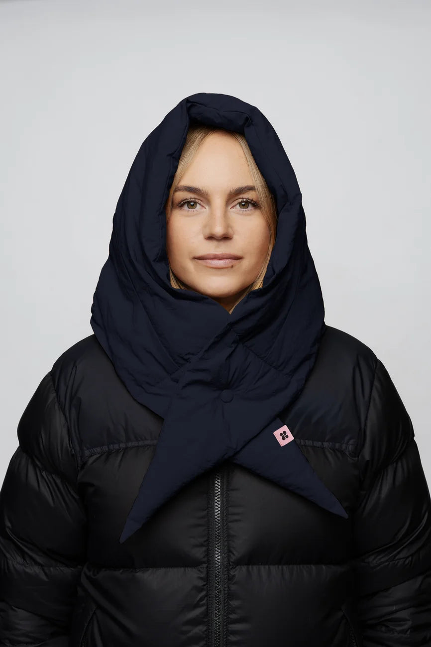 Winter Vegan Capuche Navy 5 Navy blue vegan capuche made from recycled materials, worn over a black puffer jacket. - The New Orchard - Navy Blue