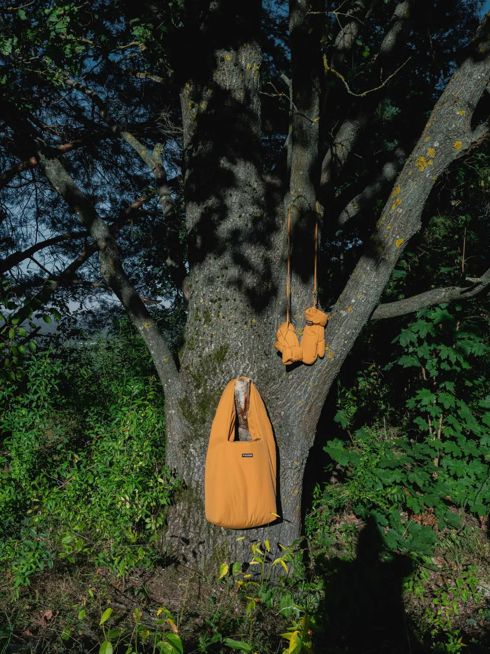 Winter Vegan Gloves Yellow 3 Amber yellow vegan winter gloves and matching tote bag made from recycled materials hanging on tree branch outdoors. - The New Orchard - Amber Yellow