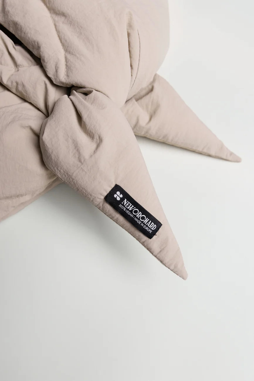 Winter Vegan Capuche Beige 7 Light beige vegan capuche made from recycled materials with a soft, textured fabric and pointed ends. - The New Orchard CH