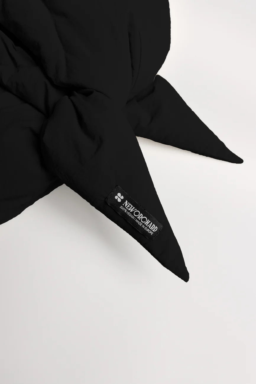 Winter Vegan Capuche Black 2 Black vegan winter capuche made from recycled materials with pointed ends and visible branded tag. - The New Orchard CH