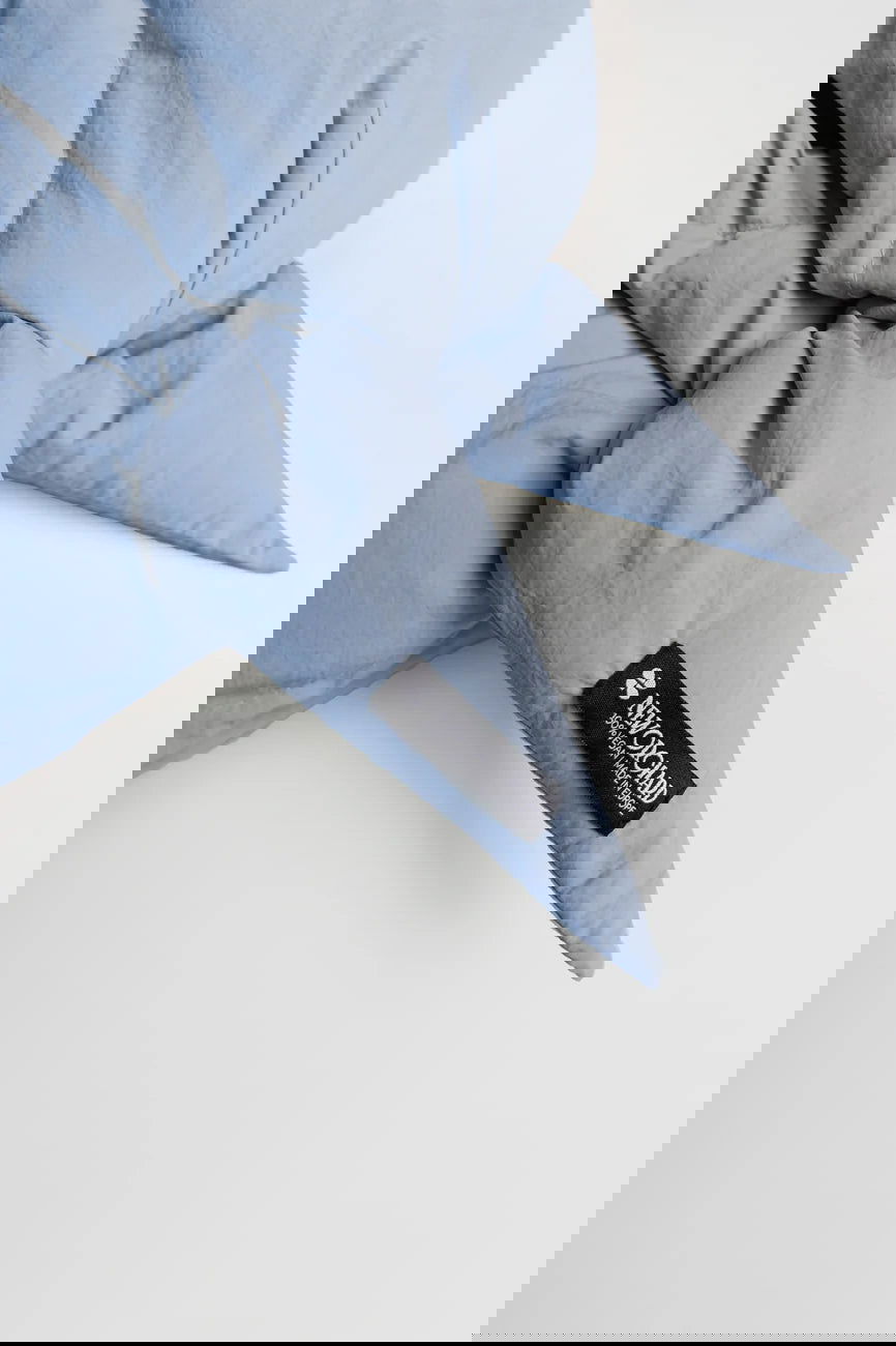 Winter Vegan Capuche Blue 2 Sky blue winter capuche made from vegan, recycled materials with brand label detail. - The New Orchard CH