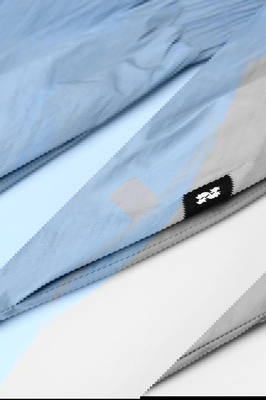 Winter Vegan Skirt Blue 4 Sky blue vegan skirt made from recycled materials with black logo tag detail. - The New Orchard CH